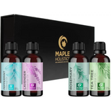 Black gift box with four pure essential oils and botanical labels for aromatherapy