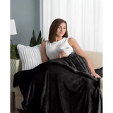 Cozy plush weighted blanket draped over a person relaxing on a couch