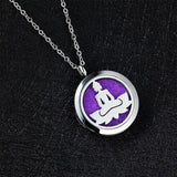 Silver Buddha pendant necklace as essential oil diffuser on purple background