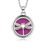 Silver dragonfly necklace diffuser pendant on a purple background for essential oil use