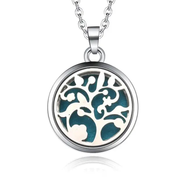 Silver Tree of Life necklace diffuser pendant on turquoise background for essential oils