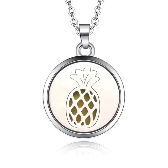 Silver necklace diffuser pendant featuring a pineapple design in a circular frame