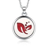 Silver necklace diffuser pendant with circular medallion and red leaf design