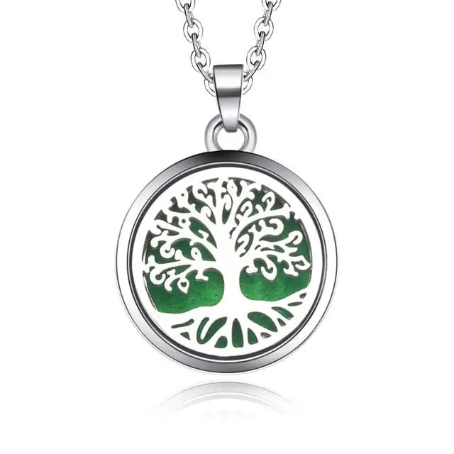 Silver necklace diffuser pendant with tree of life design on green background