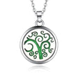 Silver necklace diffuser pendant featuring green swirling tree design in circular frame