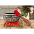 Authentic Tibetan Singing Bowl with Sanskrit Inscriptions on red cushion and wooden striker