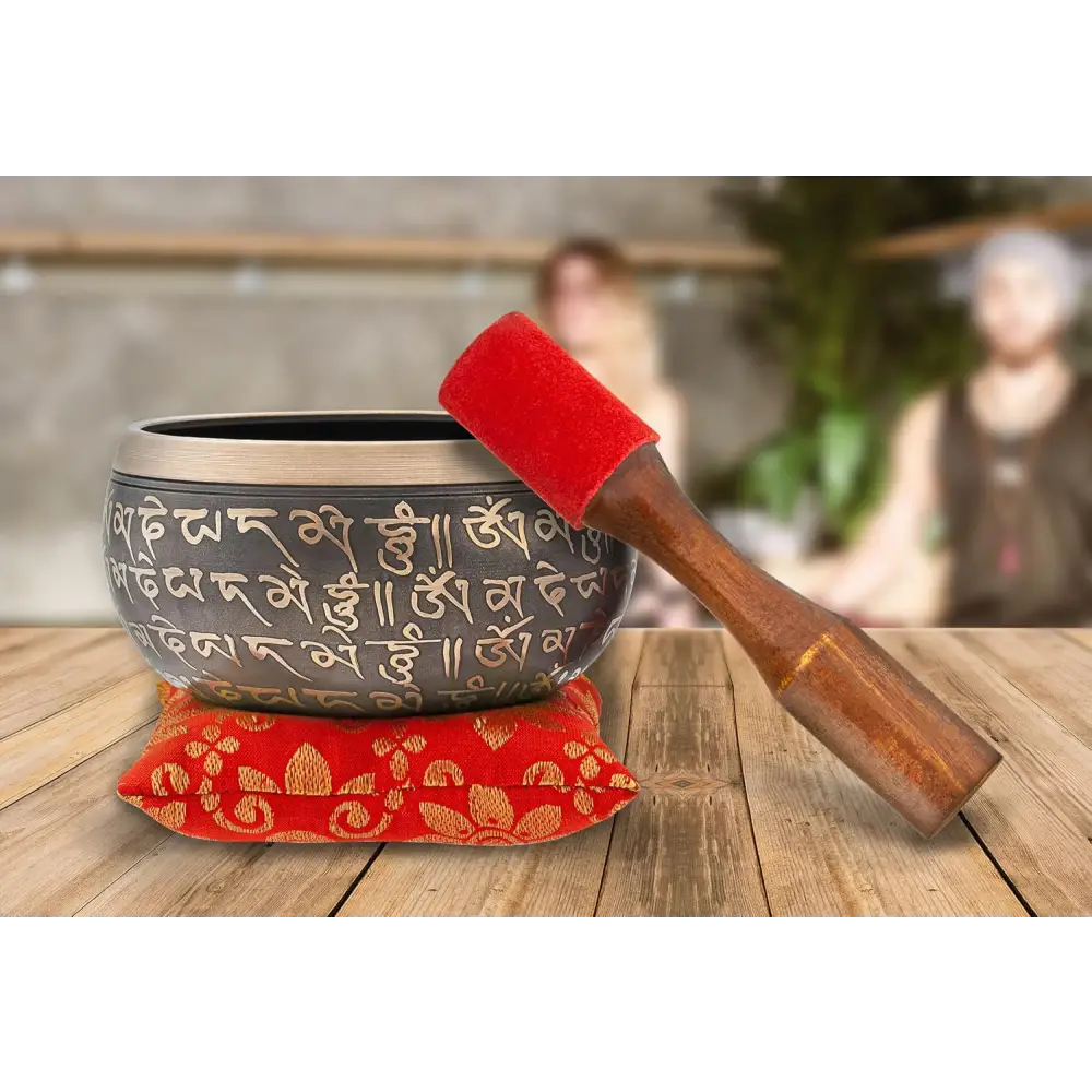 Authentic Tibetan Singing Bowl with Sanskrit Inscriptions on red cushion and wooden striker