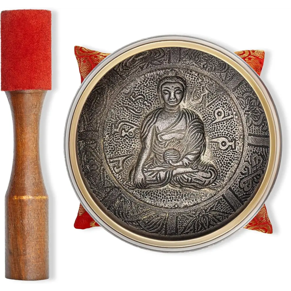 Tibetan singing bowl featuring intricate Buddha design and traditional engravings