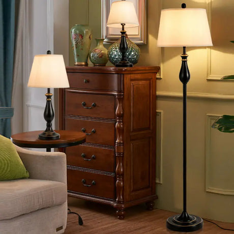 Traditional wooden chest of drawers with carved details and brushed nickel lamp set