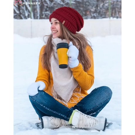 Person in a red beanie and yellow sweater enjoys winter with a slouchy winter hat