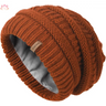 Rust-colored slouchy winter hat knit beanie with ribbed pattern and fleece lining