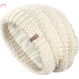 Cream-colored knit beanie with cable pattern for a stylish slouchy winter hat