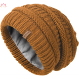 Slouchy brown knit beanie with ribbed texture and leather label for winter warmth