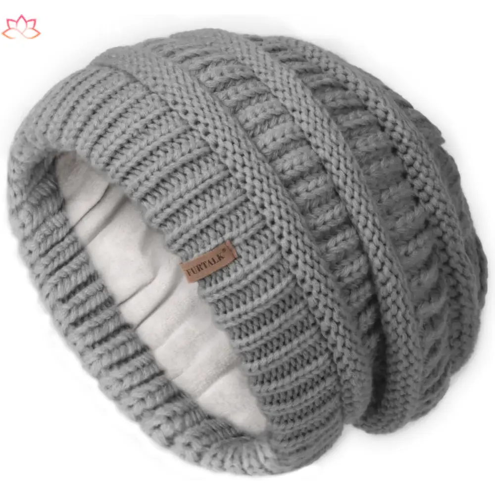 Gray knitted slouchy winter hat with textured pattern and brand tag, featuring fleece lining