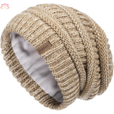 Beige knit beanie with ribbed texture and fleece lining, perfect slouchy winter hat