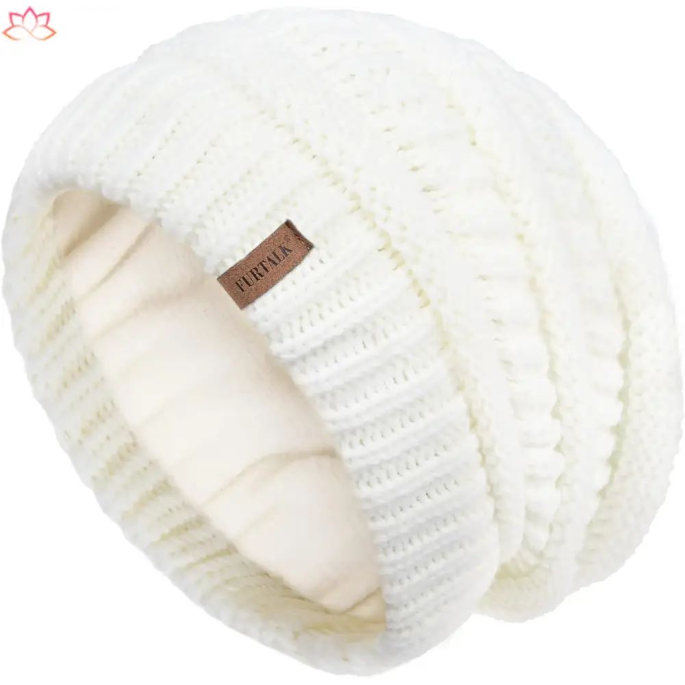 White knitted winter beanie with leather tag, perfect for slouchy winter hat style