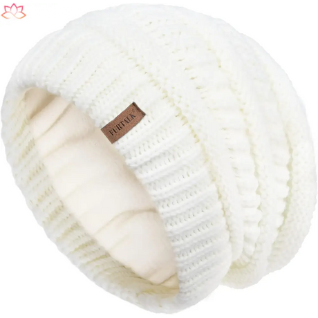 White knitted winter beanie with leather tag, perfect for slouchy winter hat style