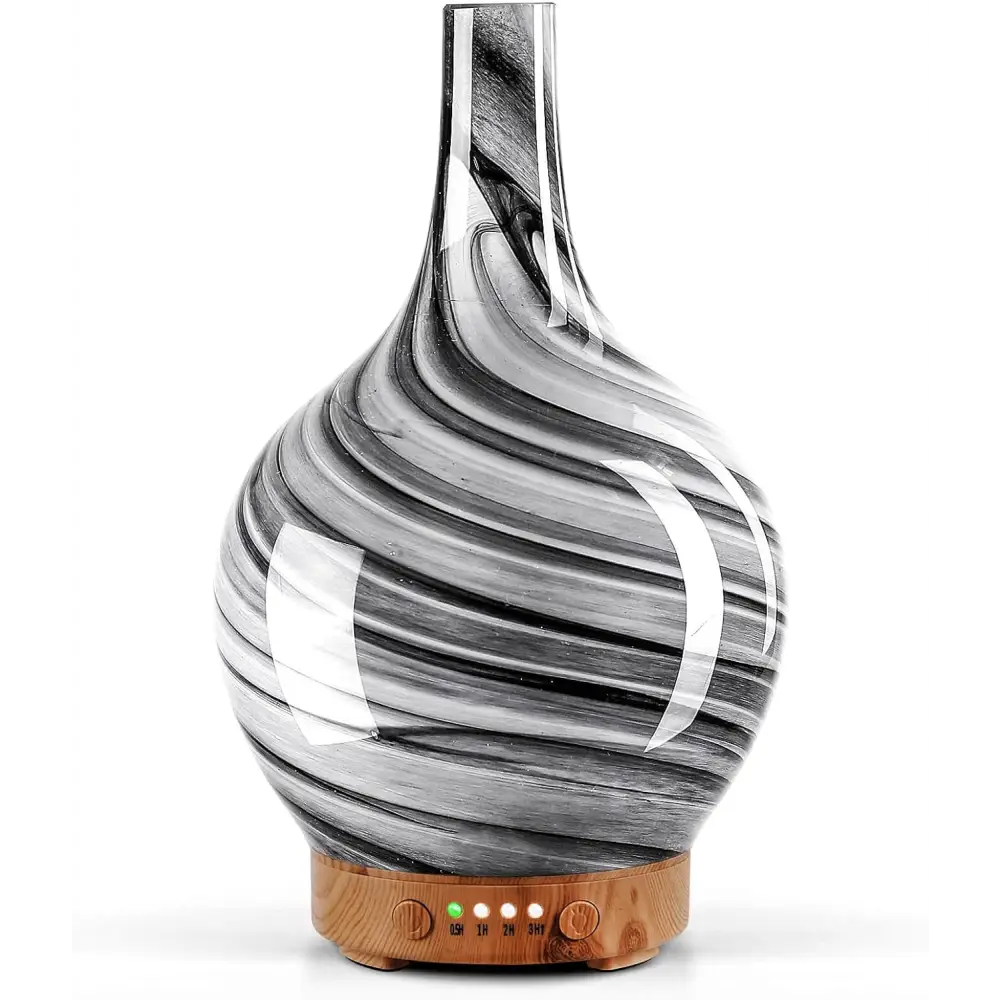 Glass diffuser with black and white swirls on wooden base for ultrasonic essential oil use