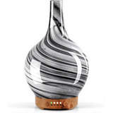 Glass diffuser with black and white swirls on wooden base for ultrasonic essential oil use