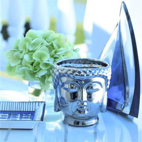 Silver metallic Buddha head planter with ornate details for essential oils or candles