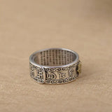 Ornate sterling silver ring with Buddha mantra engraving and decorative patterns