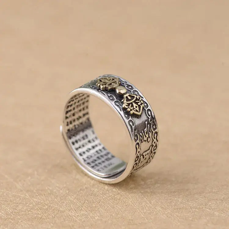 Ornate sterling silver ring featuring intricate floral patterns and Buddha mantra engraving