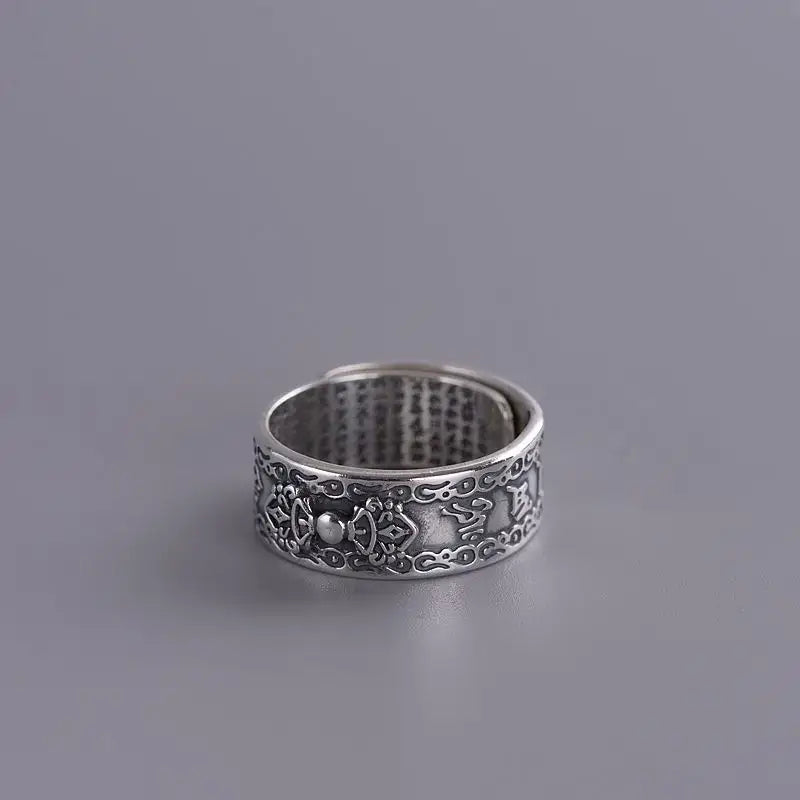 Ornate sterling silver Buddha Mantra ring with floral and scroll engravings