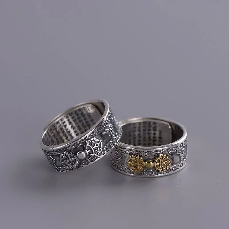 Two ornate sterling silver rings featuring floral patterns and Buddha Mantra symbols