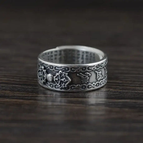 Ornate sterling silver ring with dragon engraving in Buddha Mantra design