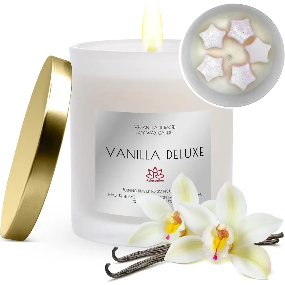 White scented soy candle with Vanilla Deluxe label, gold lid, and floral decorations