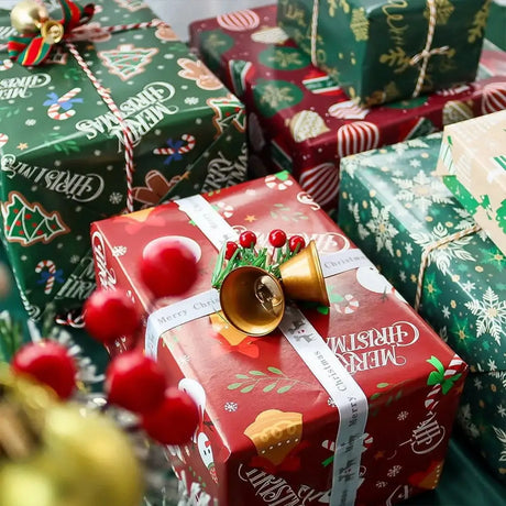 Wrapped Christmas presents with bells and berries showcasing Christmas Wrapping Paper set