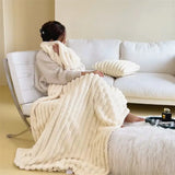 Cozy Faux Rabbit Fur Ribbed Blanket in Cream draped over a relaxing person in a chair