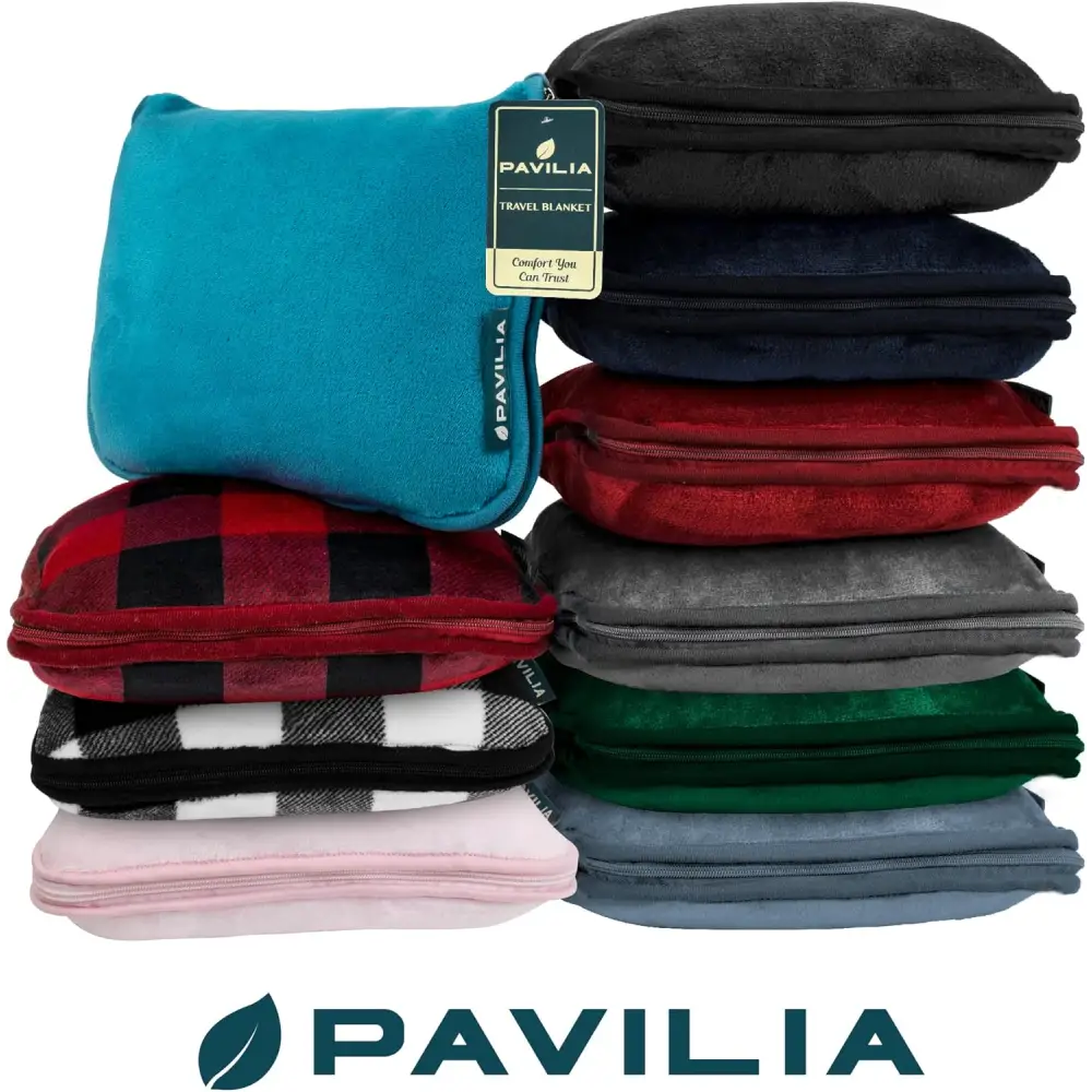 Stack of colorful Pavilia fleece blankets, perfect as a cozy travel blanket pillow