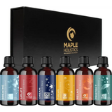 Set of six amber essential oil bottles with colorful labels in a black box