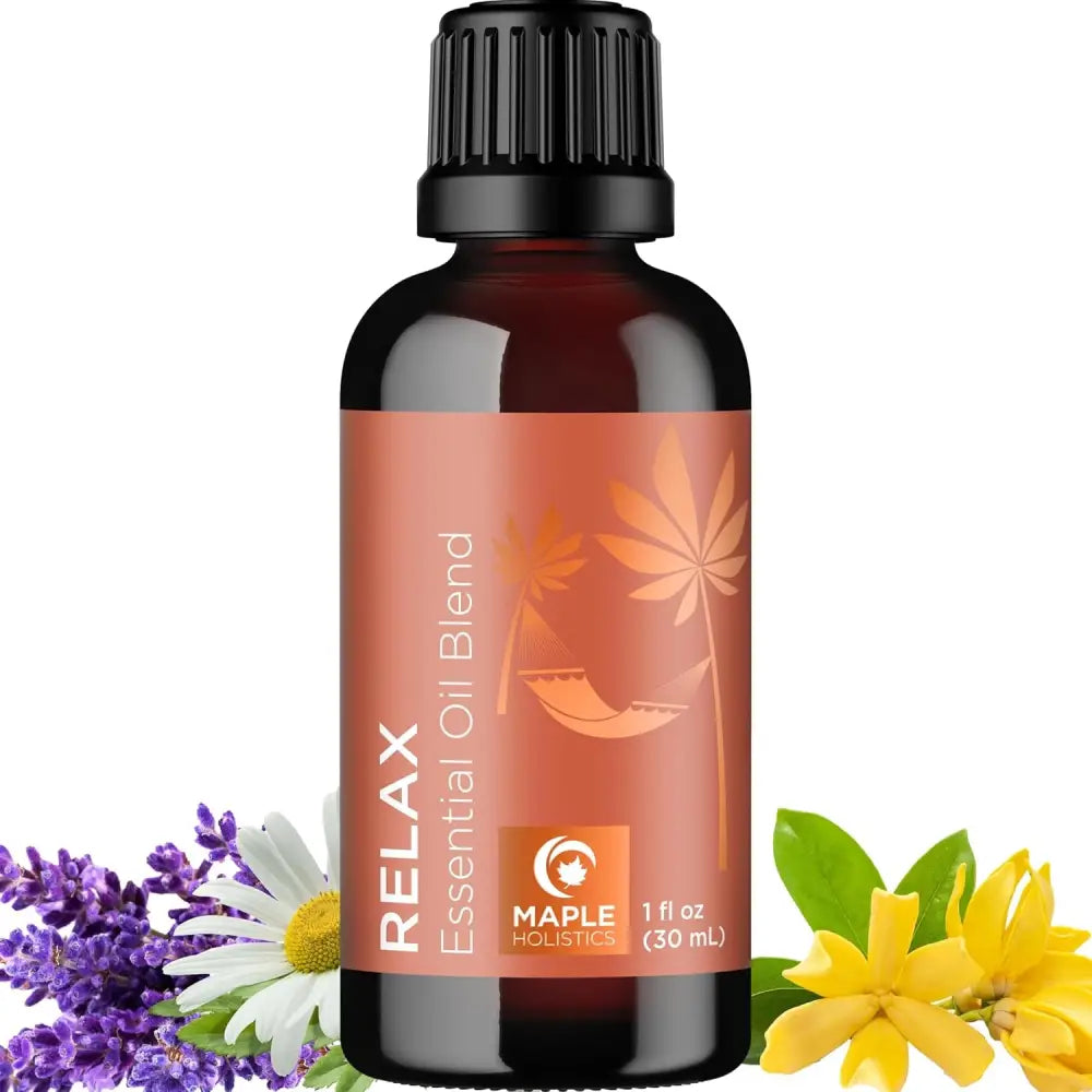 Dark amber glass bottle of Relax essential oil blend with floral accents in set