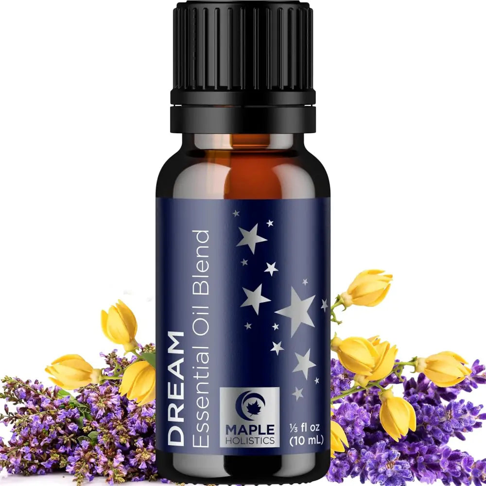 Dark glass bottle of Dream essential oil blend with stars and floral design on label