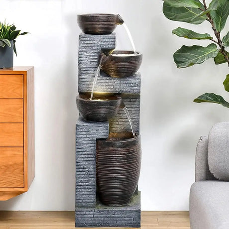 Multi-tiered water fountain with gray stone base and dark ceramic bowls for indoor outdoor use