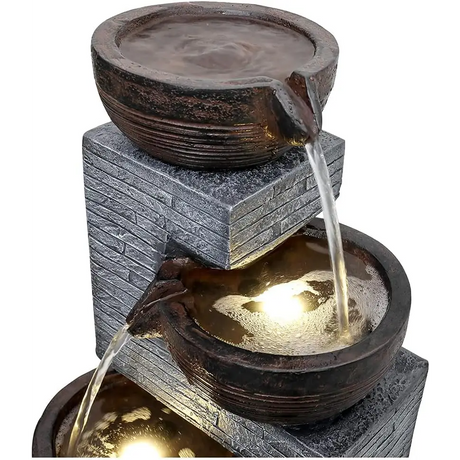 Tiered stone water fountain with illuminated cascading flow for indoor outdoor decor