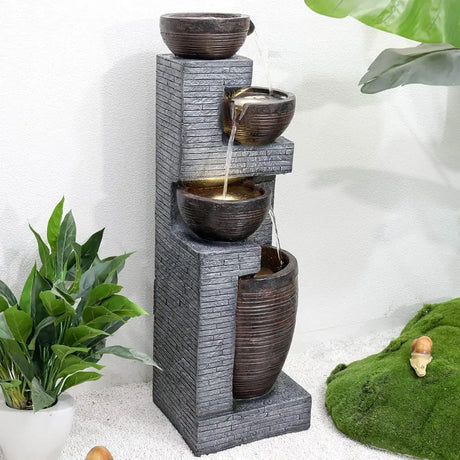 Tiered water fountain with ceramic bowls cascading on a textured gray column, indoor outdoor use