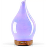 Teardrop-shaped purple glass aromatherapy oil diffuser with wooden base and LED lights