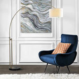 Navy blue velvet armchair pairs beautifully with Elegant Joan Arched Floor Lamp