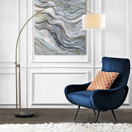 Navy blue velvet armchair pairs beautifully with Elegant Joan Arched Floor Lamp