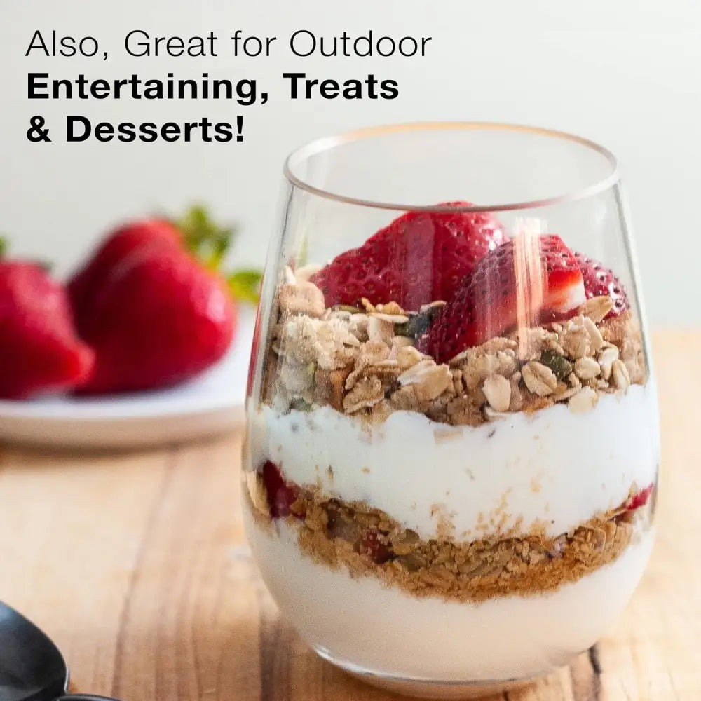 Layered dessert parfait in elegant stemless wine glasses with yogurt and strawberries