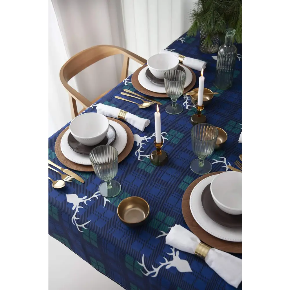 Navy blue Christmas tablecloth with white reindeer pattern for festive holiday dinners