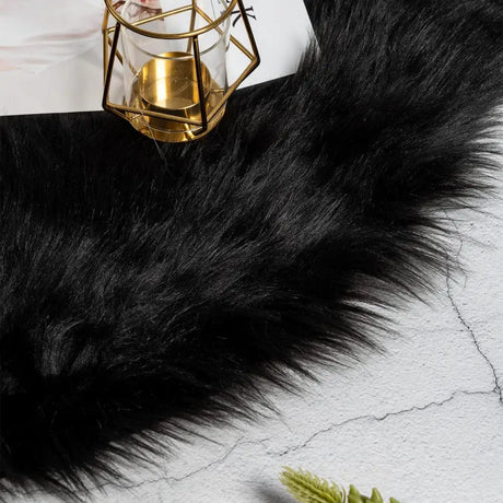 Black faux sheepskin fur textile with fluffy long pile for a cozy area rug