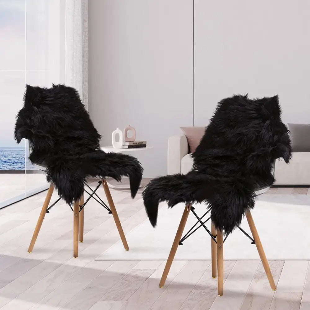 Two black faux sheepskin fur chairs with wooden legs showcased on fluffy long pile rug