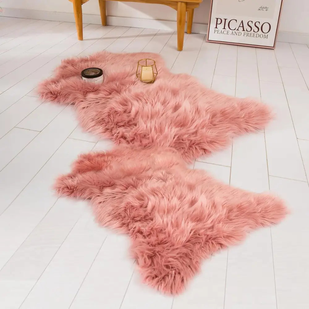 Pink fluffy long pile faux sheepskin fur area rug with a curved shape for living room