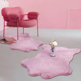 Pink plush armchair with curved metal frame on fluffy faux sheepskin fur area rug