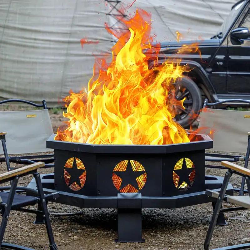 Black metal wood burning fire pit with star cutouts and vibrant flames, perfect focal point for camping trips