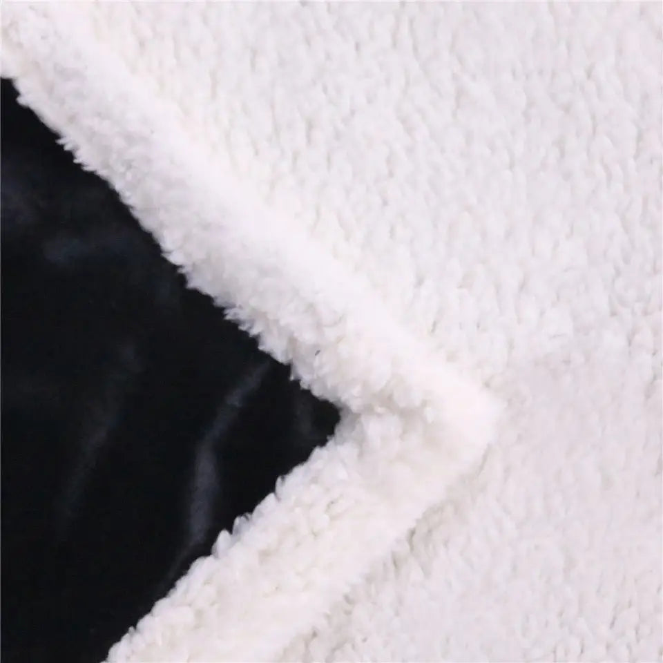 Sharp diagonal line of black and white textured fabrics on Golden Lotus Sea Turtle sherpa fluffy fleece